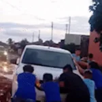 Crianças ajudam motorista a tirar carro de atoleiro em Campo Grande
